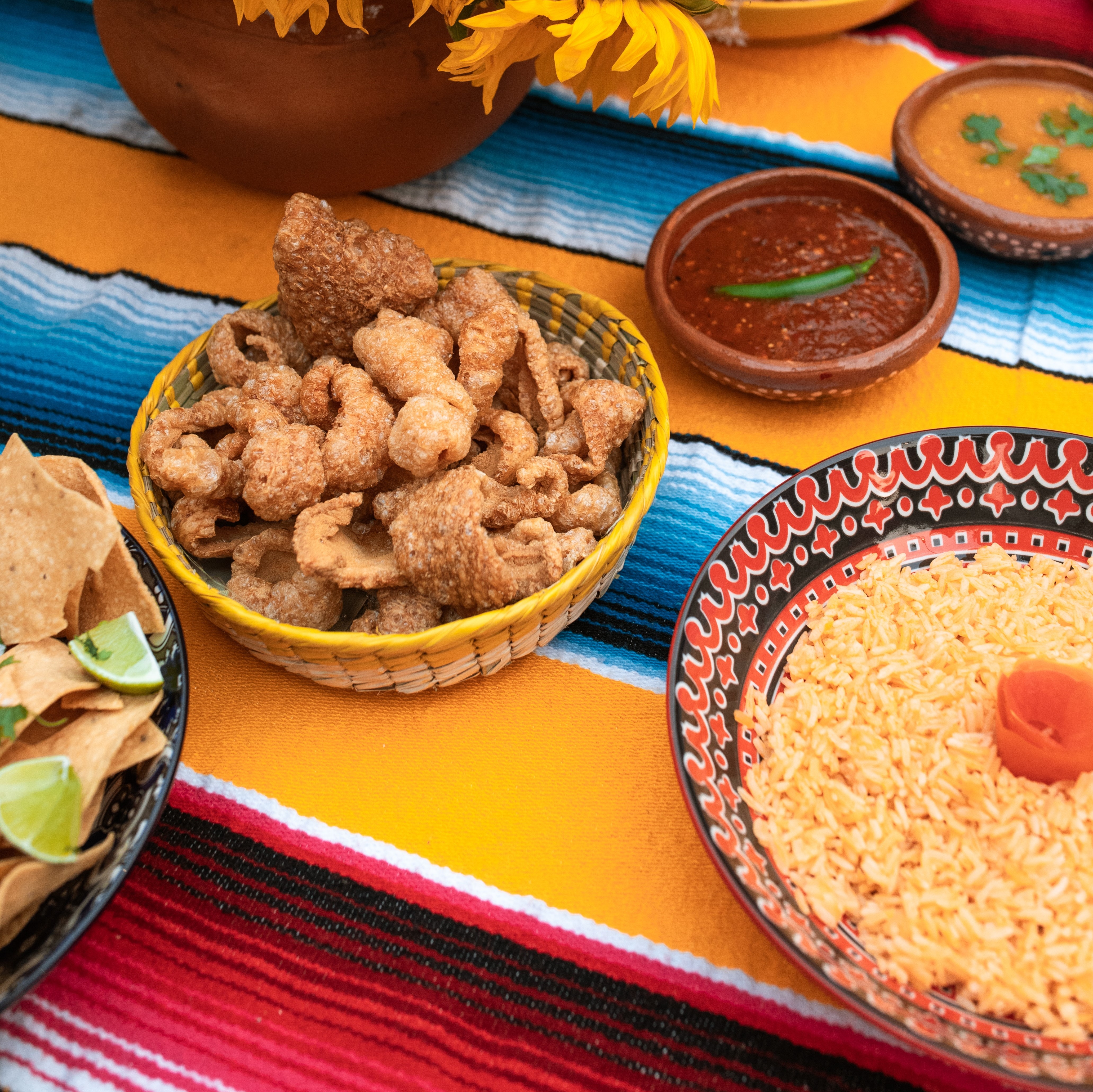 Chicharrones and other Mexican dishes on a table
